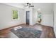 Bedroom featuring a ceiling fan, hardwood floors, and bright windows at 511 Circle Dr, Burlington, NC 27215