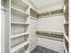 Organized walk-in closet featuring shelving on the left and hanging rods on the right at 511 Circle Dr, Burlington, NC 27215