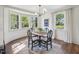 Dining area featuring a table with seating for four, large windows, and hardwood floors at 511 Circle Dr, Burlington, NC 27215