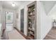 Hallway featuring hardwood floors, white walls and trim, and a built-in bookcase at 511 Circle Dr, Burlington, NC 27215