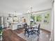 Eat-in kitchen with white cabinets, stainless steel appliances, and a bright dining area with bay windows at 511 Circle Dr, Burlington, NC 27215