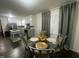 Bright dining area featuring glass table, stylish chairs, and view to updated kitchen at 513 Orange St, Oxford, NC 27565