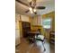 Bright eat-in kitchen with yellow walls, white cabinets, and a ceiling fan at 5138 Nc 56, Franklinton, NC 27525
