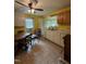 Sunny kitchen with yellow walls, white cabinets and linoleum flooring at 5138 Nc 56, Franklinton, NC 27525