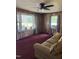 Living room featuring wood paneling, ceiling fan, and a comfortable sofa at 5138 Nc 56, Franklinton, NC 27525