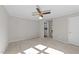 Bedroom with plush carpeting, ceiling fan, and doorway to laundry room at 541 Oak Run Dr, Raleigh, NC 27606