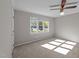 Neutral bedroom with a ceiling fan and window with natural light at 541 Oak Run Dr, Raleigh, NC 27606