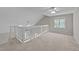 Upstairs bedroom with neutral carpet, window, ceiling fan, and railed access to below at 541 Oak Run Dr, Raleigh, NC 27606