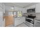 Kitchen featuring white cabinets, stainless steel appliances, and an open view to living space at 541 Oak Run Dr, Raleigh, NC 27606