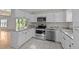Modern kitchen featuring white cabinets, granite countertops, and stainless steel appliances at 541 Oak Run Dr, Raleigh, NC 27606