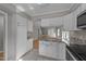 Well-lit kitchen featuring white cabinets and granite countertops, open to the living area at 541 Oak Run Dr, Raleigh, NC 27606