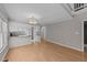 Open living space with kitchen view, featuring hardwood floors and a modern light fixture at 541 Oak Run Dr, Raleigh, NC 27606