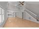 Bright living room with hardwood floors, vaulted ceiling, and an open staircase to the second floor at 541 Oak Run Dr, Raleigh, NC 27606