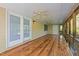 Screened-in porch with wood flooring and ceiling fans at 541 Oak Run Dr, Raleigh, NC 27606