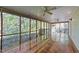 Relaxing screened porch with hardwood flooring and ceiling fans overlooking a lush backyard at 541 Oak Run Dr, Raleigh, NC 27606