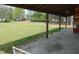 View of large backyard from covered porch, showcasing spacious lawn and mature trees at 5531 Autry Rd, Rocky Mount, NC 27803