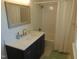 Bathroom featuring updated vanity with a quartz countertop, gold hardware, and tub at 5531 Autry Rd, Rocky Mount, NC 27803