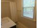 Bathroom featuring window and view of the outside plus a vanity with gold hardware at 5531 Autry Rd, Rocky Mount, NC 27803