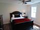 Relaxing bedroom with black wooden bed frame and a ceiling fan at 5531 Autry Rd, Rocky Mount, NC 27803