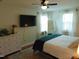 This bedroom has a large TV, windows with natural light and plenty of storage space at 5531 Autry Rd, Rocky Mount, NC 27803