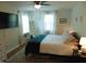 Bright bedroom featuring hardwood floors, a ceiling fan, and natural light from the window at 5531 Autry Rd, Rocky Mount, NC 27803