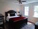 Bright bedroom with a black bed frame, two windows, and a view of the outdoors at 5531 Autry Rd, Rocky Mount, NC 27803