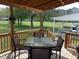 Cozy covered back porch with outdoor seating and a view of the spacious backyard at 5531 Autry Rd, Rocky Mount, NC 27803