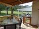 Back porch with seating area overlooking backyard and carport area at 5531 Autry Rd, Rocky Mount, NC 27803