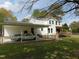 Charming two-story home with a carport and fenced yard with classic cars at 5531 Autry Rd, Rocky Mount, NC 27803