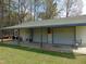 Exterior of garage with white siding, multiple garage doors, and covered porch area at 5531 Autry Rd, Rocky Mount, NC 27803