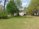 Two-story home with white siding, a back porch, and large lawn at 5531 Autry Rd, Rocky Mount, NC 27803