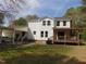 Backyard view of a two-story home featuring a covered deck and carport at 5531 Autry Rd, Rocky Mount, NC 27803