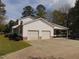 Charming two-story home featuring a two-car garage and carport on a sunny day at 5531 Autry Rd, Rocky Mount, NC 27803