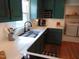 Updated kitchen with green cabinets, subway tile backsplash, and quartz countertops at 5531 Autry Rd, Rocky Mount, NC 27803