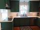 Updated kitchen featuring painted cabinets, stainless appliances, backsplash, and hardwood floors at 5531 Autry Rd, Rocky Mount, NC 27803