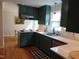 Updated kitchen featuring painted cabinets, hardwood floors, and white countertops at 5531 Autry Rd, Rocky Mount, NC 27803