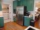 Bright kitchen featuring painted cabinets, stainless steel appliances, and hardwood flooring at 5531 Autry Rd, Rocky Mount, NC 27803
