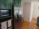 Updated kitchen with stainless steel appliances, painted cabinets, and hardwood flooring at 5531 Autry Rd, Rocky Mount, NC 27803