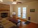 Cozy living area with a brick fireplace, access to the outdoor patio, and hardwood flooring at 5531 Autry Rd, Rocky Mount, NC 27803