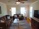 Inviting living room featuring hardwood floors, a ceiling fan, and comfortable seating at 5531 Autry Rd, Rocky Mount, NC 27803