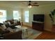 Comfortable living room with a ceiling fan, large windows, and hardwood floors at 5531 Autry Rd, Rocky Mount, NC 27803