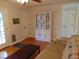 A brightly lit living room with a white cabinet, neutral sofa, and wood flooring at 5531 Autry Rd, Rocky Mount, NC 27803