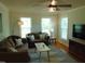 Cozy living room offering lots of natural light, a ceiling fan, and hardwood floors at 5531 Autry Rd, Rocky Mount, NC 27803