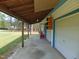 Covered patio with a view of the expansive lawn and mature trees at 5531 Autry Rd, Rocky Mount, NC 27803