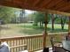 View from a porch showcasing a large lawn and mature trees in the backyard at 5531 Autry Rd, Rocky Mount, NC 27803