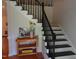Elegant staircase with dark railings, contrasting with the light walls and providing access to the upper level at 5531 Autry Rd, Rocky Mount, NC 27803