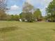 Wide view of a home situated on a large grassy lot with mature trees at 5531 Autry Rd, Rocky Mount, NC 27803