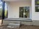 Step-down patio featuring concrete steps for backyard access, enhanced by the natural light reflecting from the sliding glass door at 5875 Green Pine Rd, Cedar Grove, NC 27231