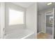 Bathroom featuring a bathtub, a window, and a sliding glass shower door at 624 S Kennelman Cir, Wendell, NC 27591