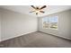 Bedroom featuring neutral walls, carpet, two bright windows, and a ceiling fan at 624 S Kennelman Cir, Wendell, NC 27591